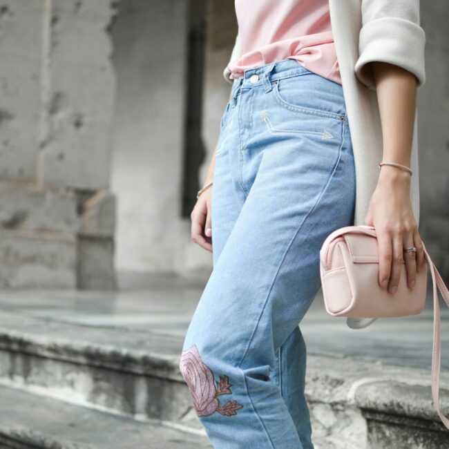 women holding pink leather crossbody bag on stair